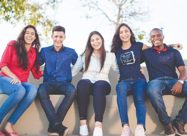 Group of friends smiling on a bench